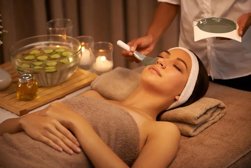 Therapist preparing a client for a facial treatment
